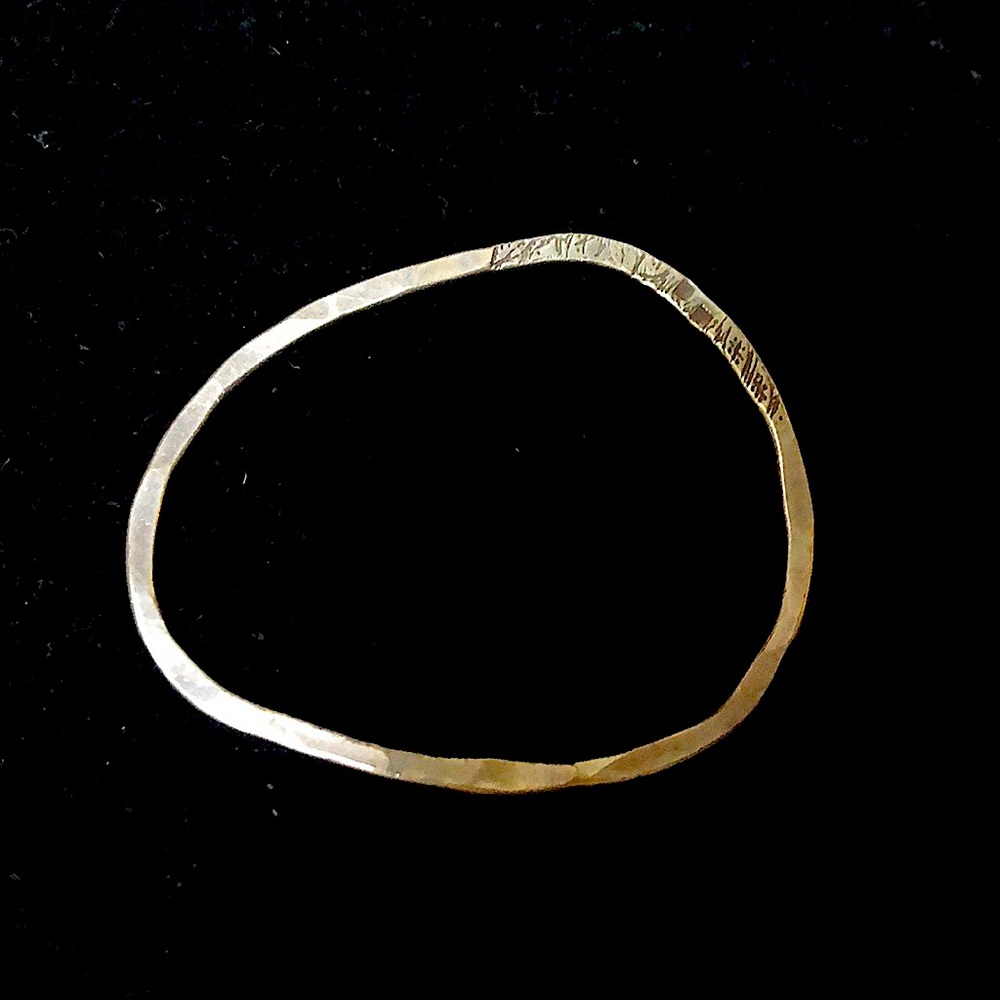 Asymmetrical handmade hammered silver bracelet.
